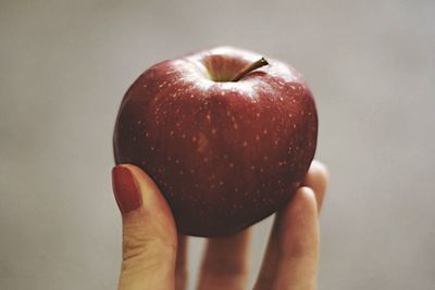 Close-up of hand holding apple