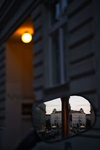 Close-up of illuminated buildings against sky at dusk