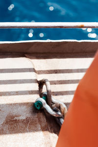 Water shine, sun and shadow light, detail of a boat. orange details