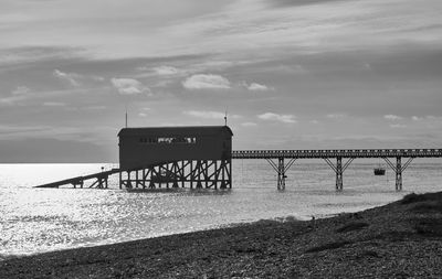 Pier over sea against sky