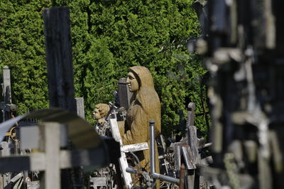 Statue of cemetery against trees