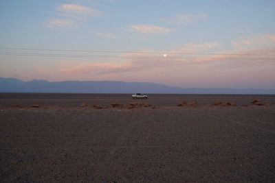 Scenic view of beach against sky during sunset