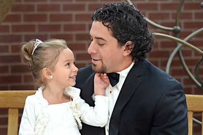 Father and girl looking at camera