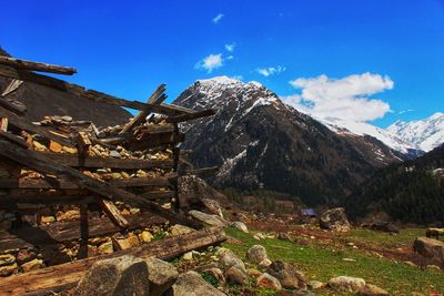 Scenic view of snowcapped mountains against blue sky