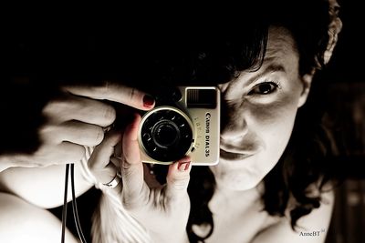 Close-up of woman photographing through smart phone