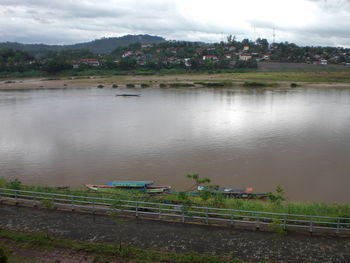 Scenic view of lake against cloudy sky