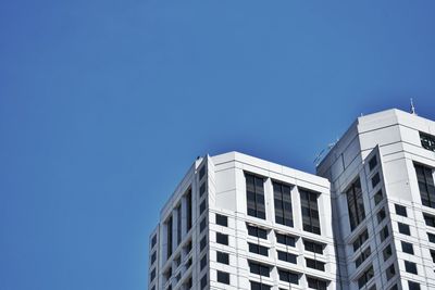 Low angle view of modern building against clear blue sky