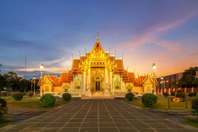 View of temple building against sky at sunset