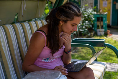 Midsection of woman sitting on chair