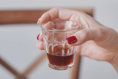 Close-up of woman holding drink glass 