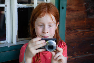 Portrait of a girl holding camera