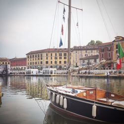 Boats in river with buildings in background