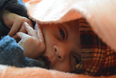 Close-up of newborn baby girl wrapped in blanket
