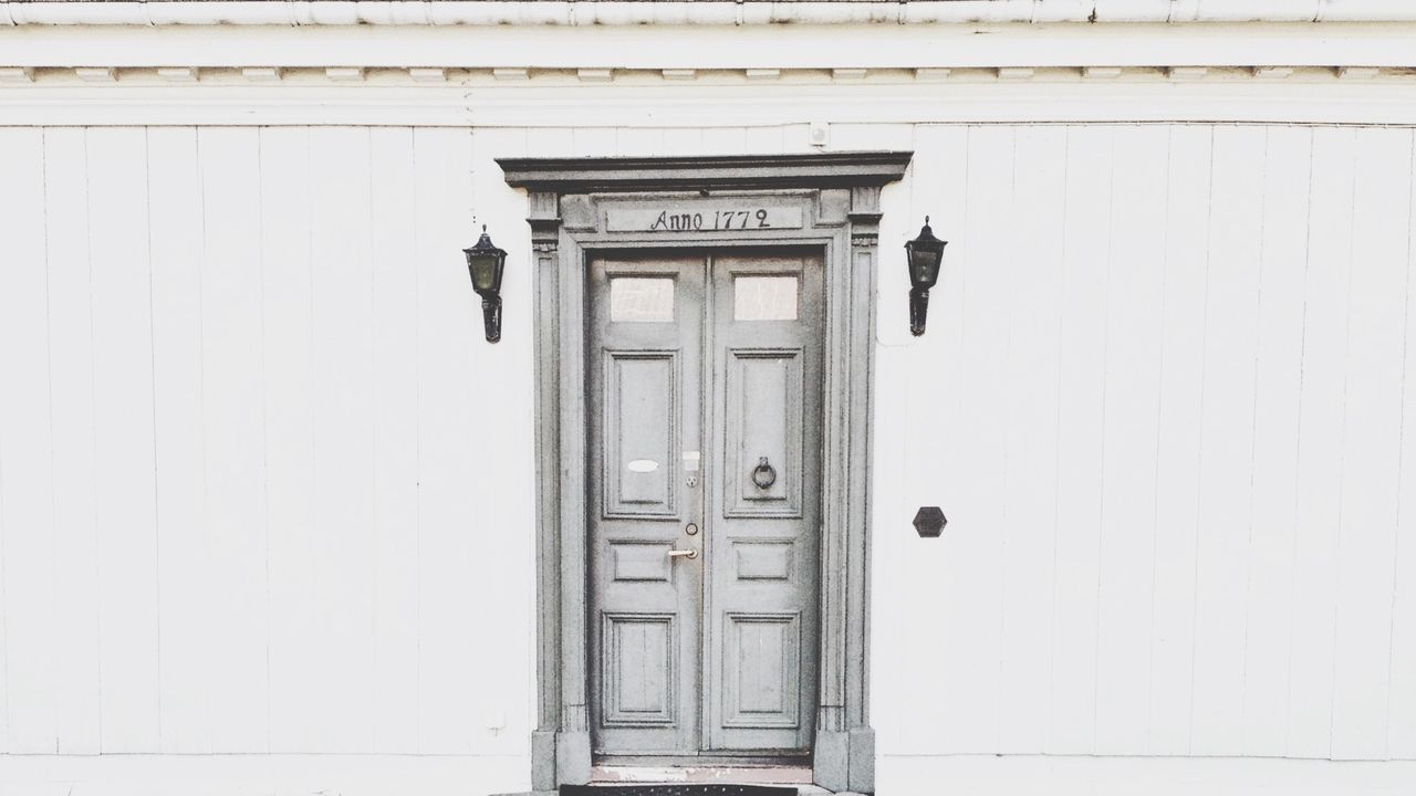 architecture, built structure, door, building exterior, closed, entrance, safety, window, wall - building feature, protection, security, day, low angle view, doorway, outdoors, arch, building, wall, facade, old