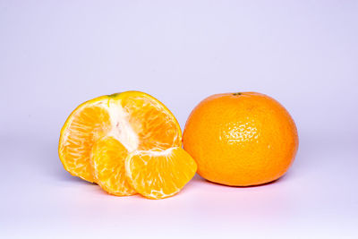 Close-up of orange fruit against white background