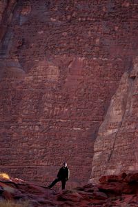 Full length of man standing against rock formation