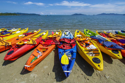 Colorful kayaks on shore at beach