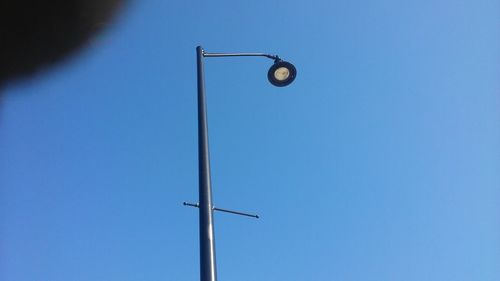 Low angle view of windmill against clear blue sky