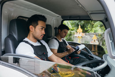 Portrait of senior man sitting in car