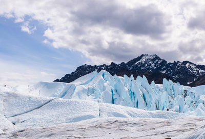 Scenic view of snow covered mountains against sky