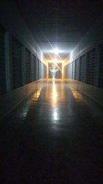 Empty illuminated tunnel at night
