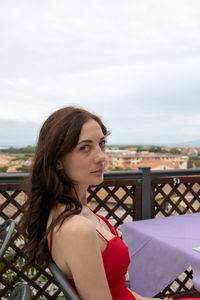 Portrait of women sitting by table at cafe against sky