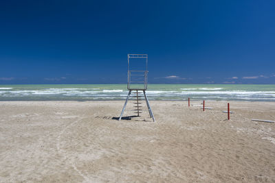 Scenic view of beach against blue sky