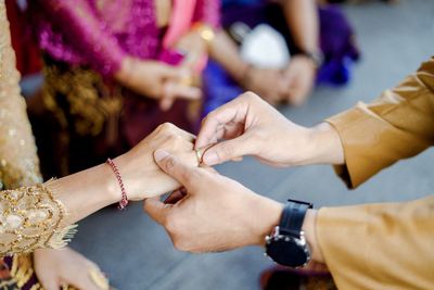 Cropped image of couple holding hands