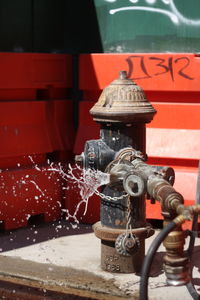 Water flowing from fire hydrant on sidewalk