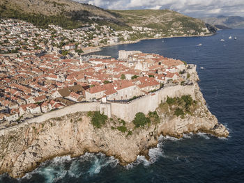 High angle view of townscape by sea