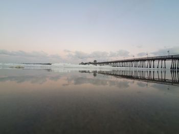 Bridge over sea against sky