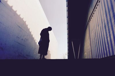 Silhouette of man standing against sky