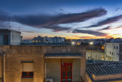 Buildings against sky at sunset