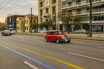 Cars on street against buildings in city