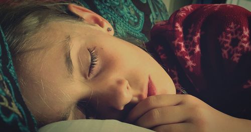 Close-up of girl sleeping on sofa