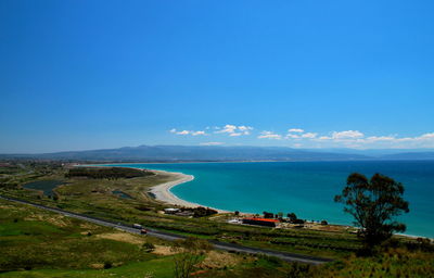 Scenic view of beach against blue sky