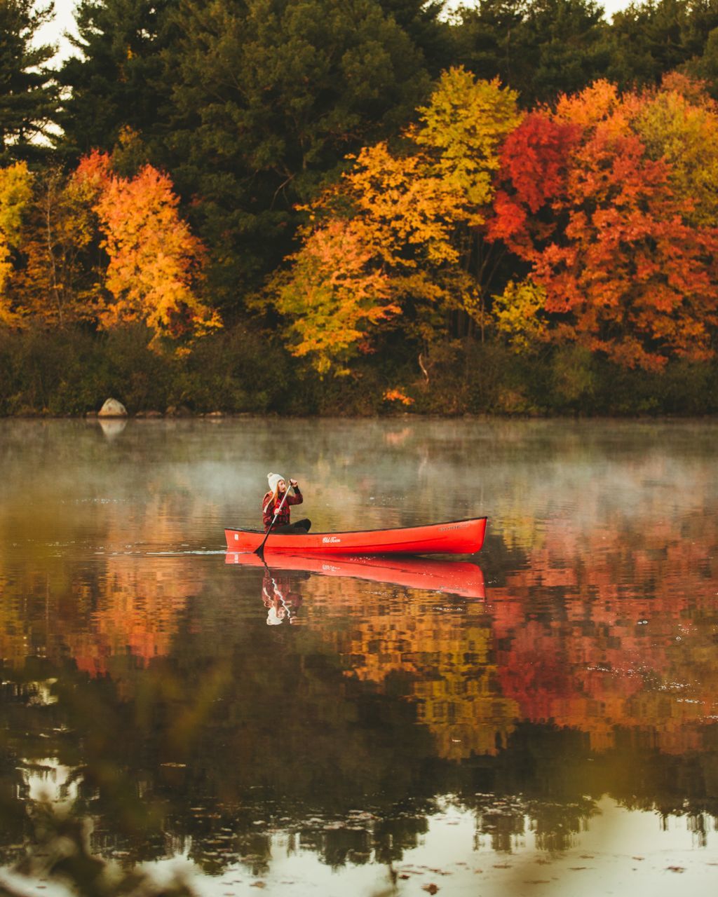 water, tree, lake, autumn, change, plant, nature, reflection, orange color, real people, waterfront, beauty in nature, nautical vessel, one person, lifestyles, day, tranquility, leisure activity, transportation, outdoors