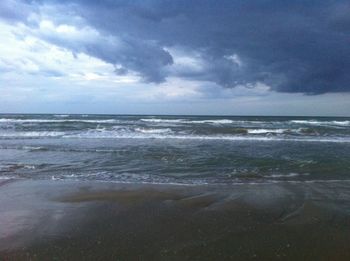 Scenic view of sea against cloudy sky