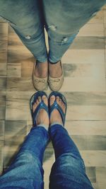 Low section of woman standing on hardwood floor