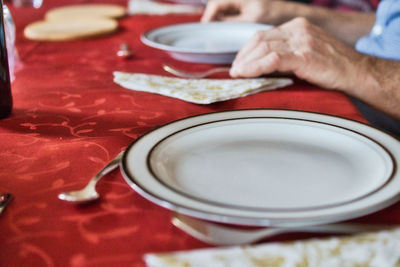 Close-up of hand holding tea cup on table