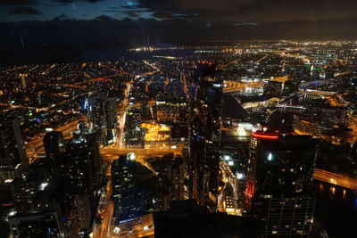 High angle view of city lit up at night