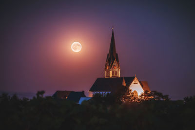 Traditional building against sky at night