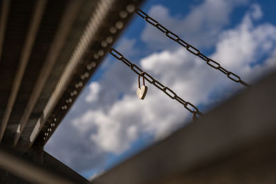 Low angle view of barbed wire against sky