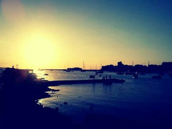 Boat in sea at sunset