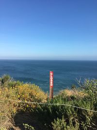 Scenic view of sea against clear blue sky