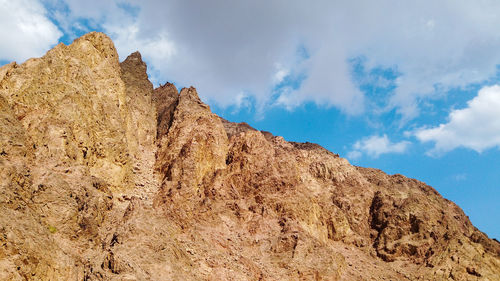 Low angle view of rock formations against sky