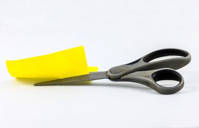 Close-up of yellow object over white background