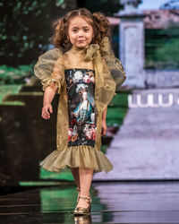 Full length portrait of girl standing outdoors