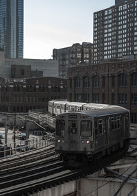 Elevated train along built structures