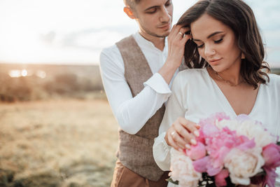 Young couple holding flower bouquet